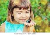 child holding caterpillar
